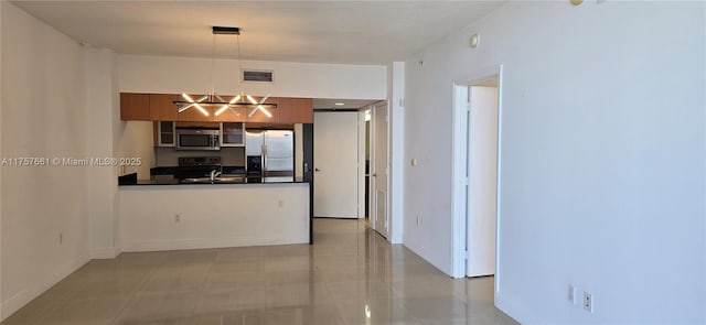 kitchen with visible vents, a peninsula, glass insert cabinets, appliances with stainless steel finishes, and dark countertops