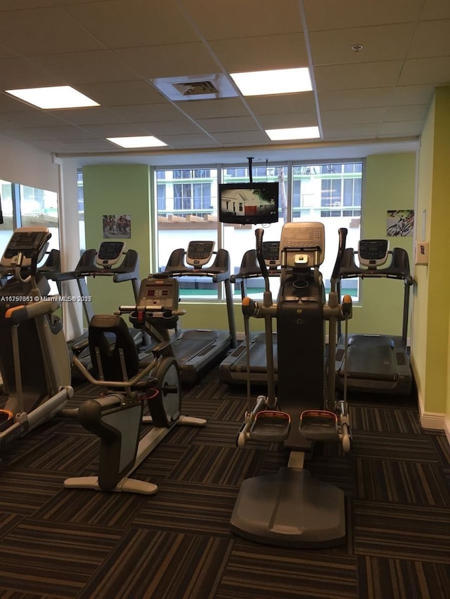 gym with visible vents, a paneled ceiling, and carpet