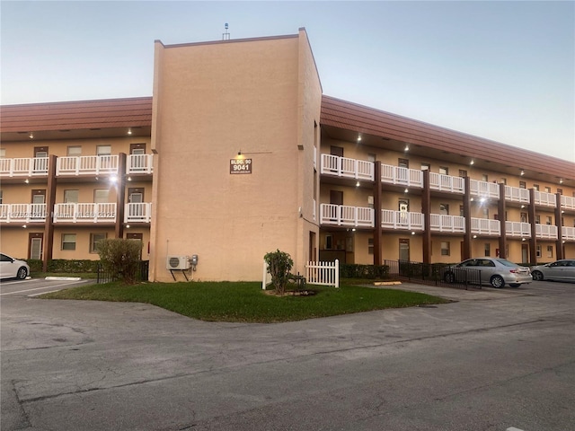 view of building exterior featuring uncovered parking