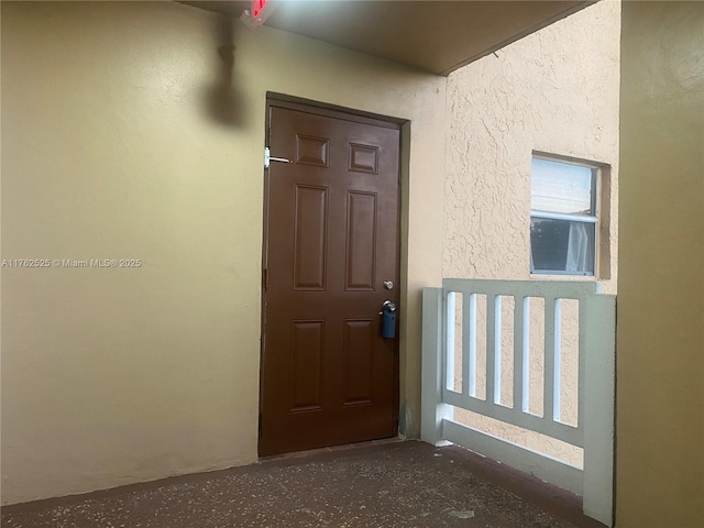 property entrance featuring stucco siding