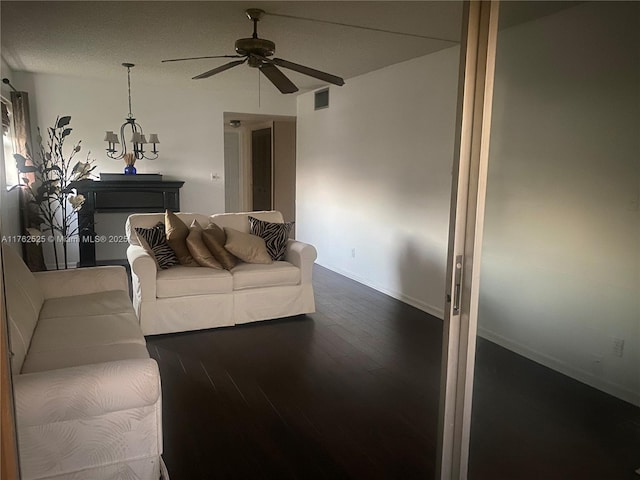 living room featuring dark wood finished floors, a ceiling fan, visible vents, and baseboards