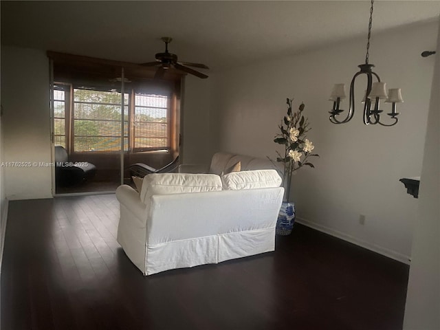 living room with a ceiling fan, wood finished floors, and baseboards