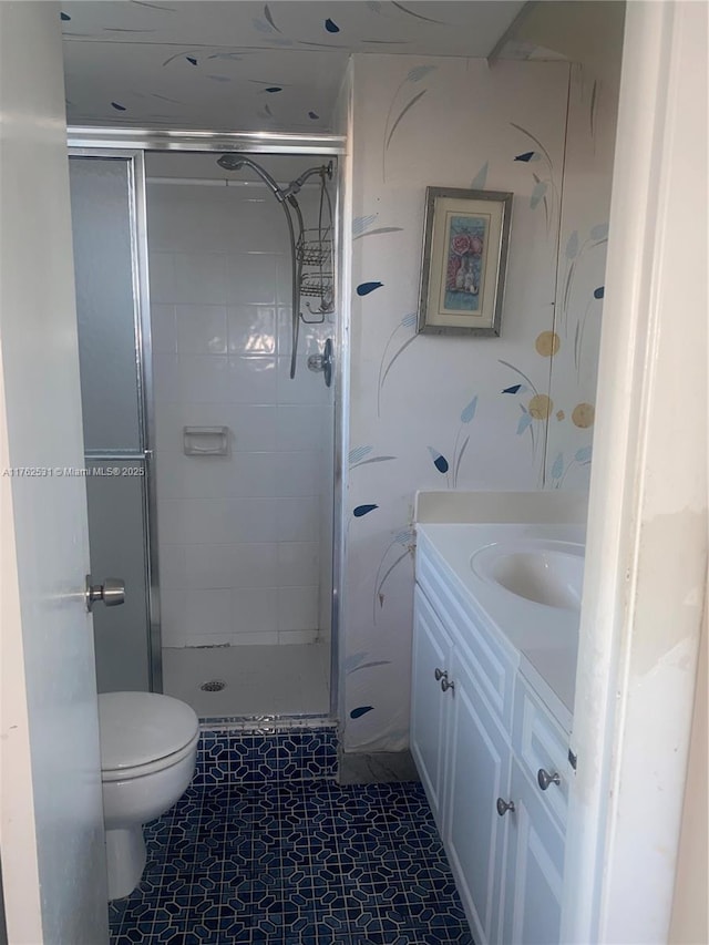 full bath with toilet, a stall shower, and vanity