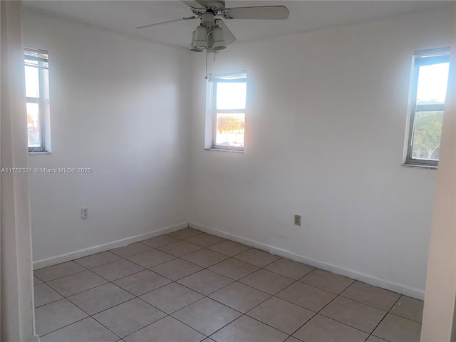 empty room featuring a ceiling fan and baseboards