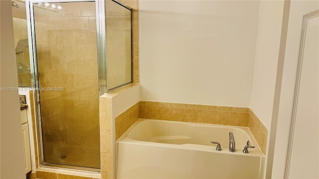 bathroom featuring a garden tub and a stall shower