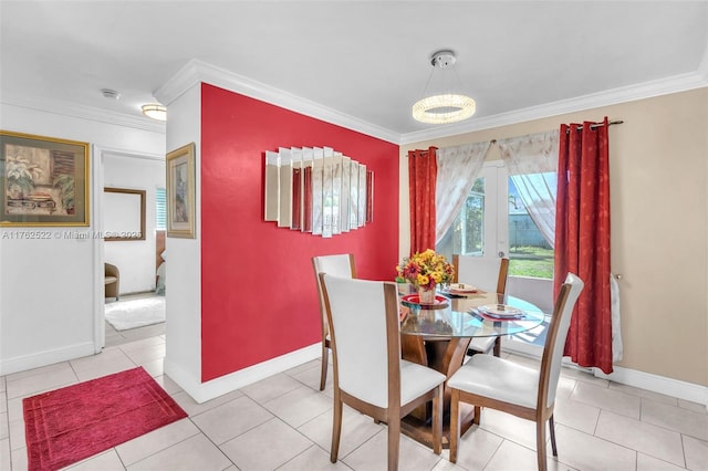 dining room featuring tile patterned floors, baseboards, and ornamental molding