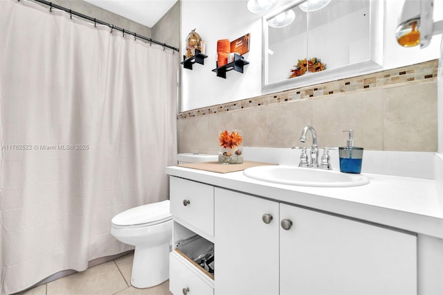 full bath featuring toilet, vanity, a shower with curtain, tile patterned floors, and tile walls