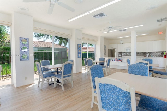 sunroom with visible vents and a ceiling fan