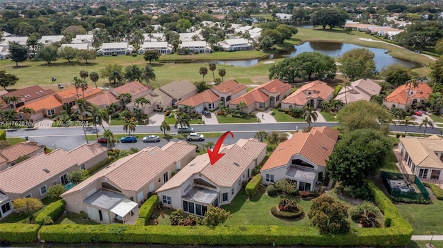 drone / aerial view with a residential view and a water view