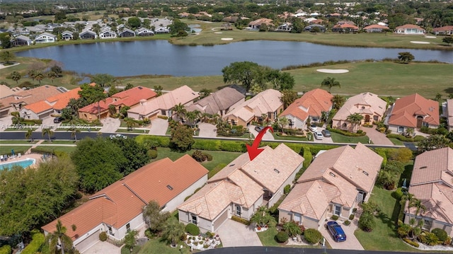 drone / aerial view with a residential view and a water view