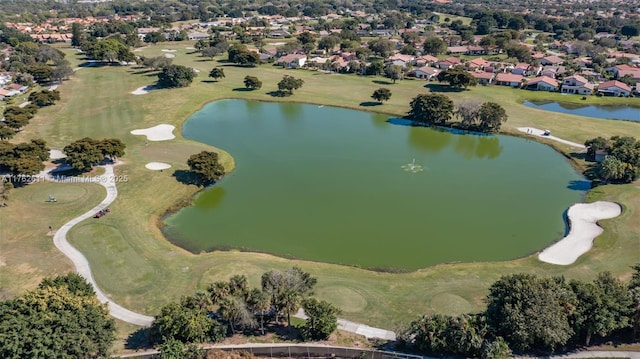 drone / aerial view featuring a residential view, a water view, and golf course view