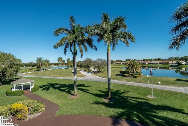 view of home's community featuring a yard and a water view