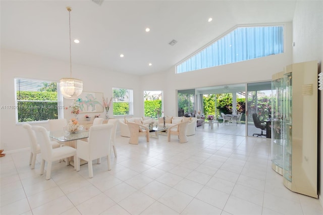 unfurnished dining area with light tile patterned floors, recessed lighting, a wealth of natural light, and high vaulted ceiling