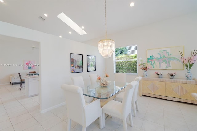 dining space featuring light tile patterned floors, visible vents, lofted ceiling with skylight, and an inviting chandelier