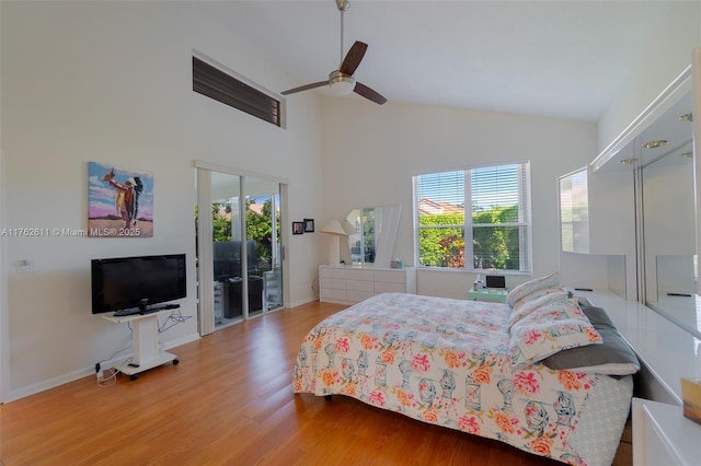 bedroom with a ceiling fan, wood finished floors, baseboards, high vaulted ceiling, and access to outside