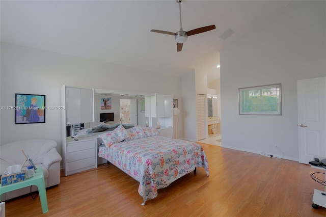 bedroom with visible vents, light wood-style flooring, high vaulted ceiling, and ceiling fan