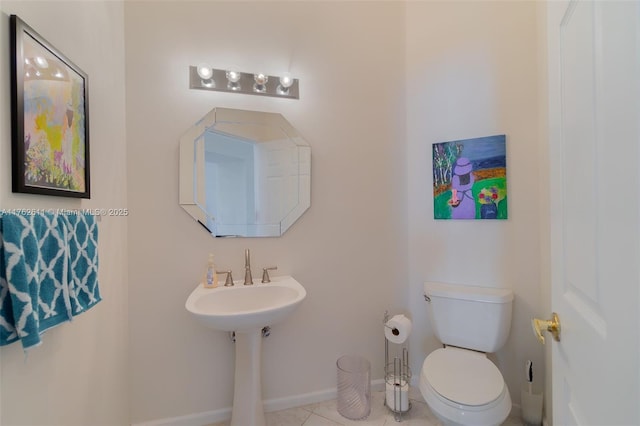 bathroom featuring tile patterned floors, toilet, and baseboards