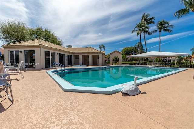 pool featuring a patio and fence