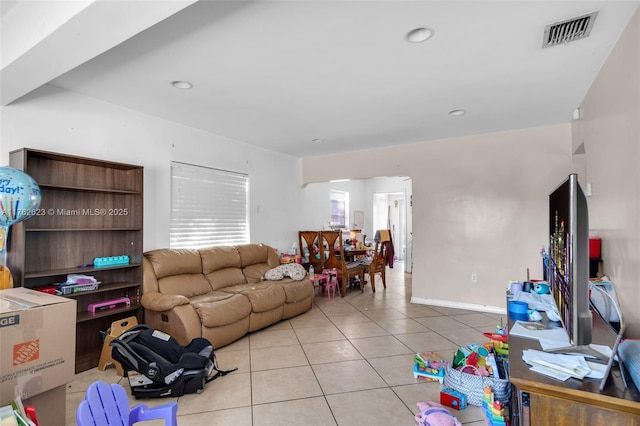 tiled living room featuring recessed lighting, visible vents, and baseboards