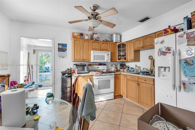 kitchen with visible vents, tasteful backsplash, white appliances, light tile patterned flooring, and light countertops