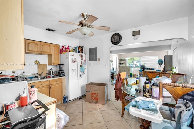 kitchen with light tile patterned floors, a sink, decorative backsplash, light countertops, and white fridge with ice dispenser