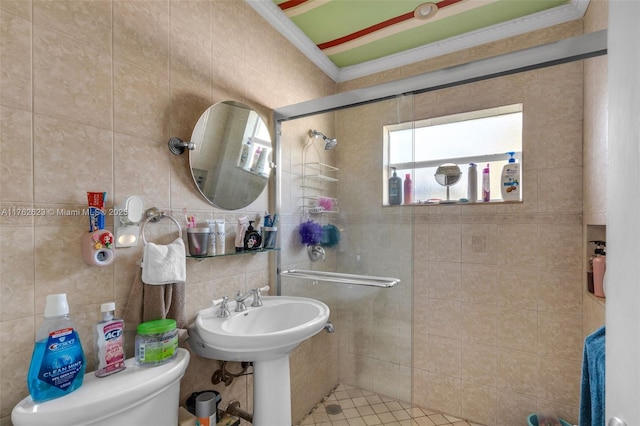 bathroom with a stall shower, ornamental molding, tile walls, toilet, and backsplash