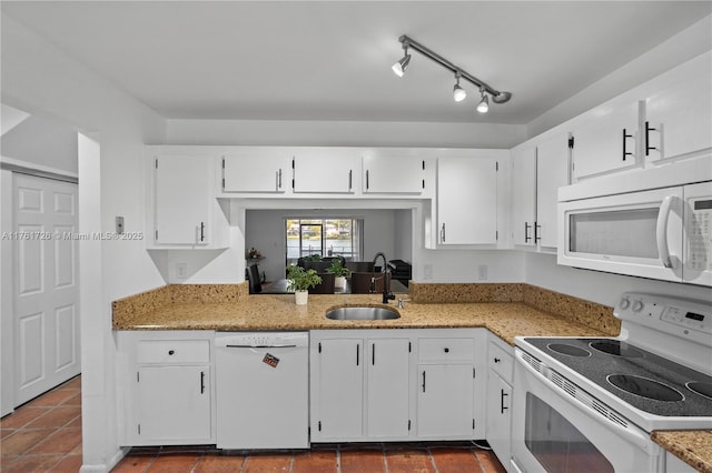 kitchen featuring white appliances, white cabinetry, and a sink