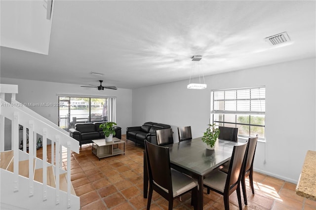 dining room with visible vents, baseboards, and ceiling fan