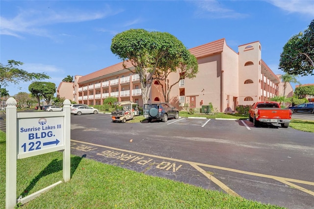 view of property featuring uncovered parking