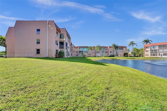 view of home's community featuring a yard and a water view