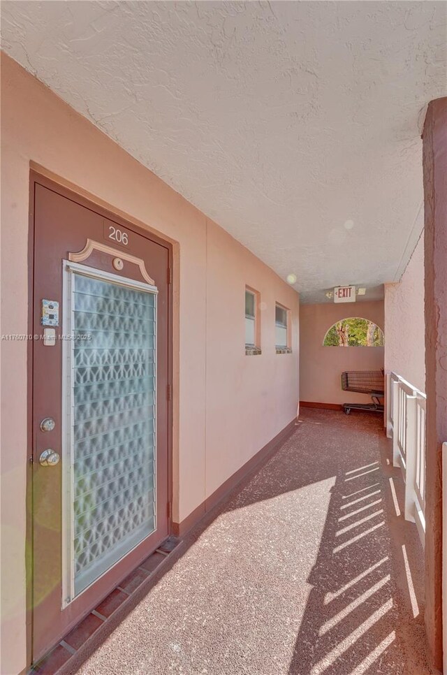 interior space with baseboards and a textured ceiling