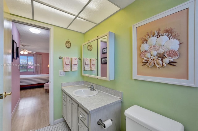 ensuite bathroom featuring ensuite bathroom, toilet, and vanity