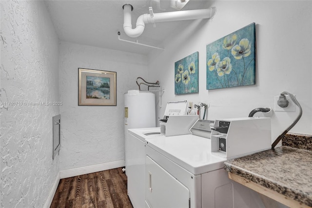 washroom featuring baseboards, washer and clothes dryer, dark wood-style floors, and a textured wall