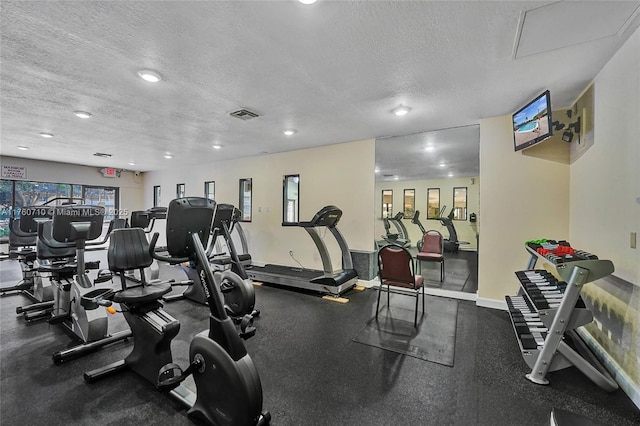 gym featuring recessed lighting, baseboards, visible vents, and a textured ceiling