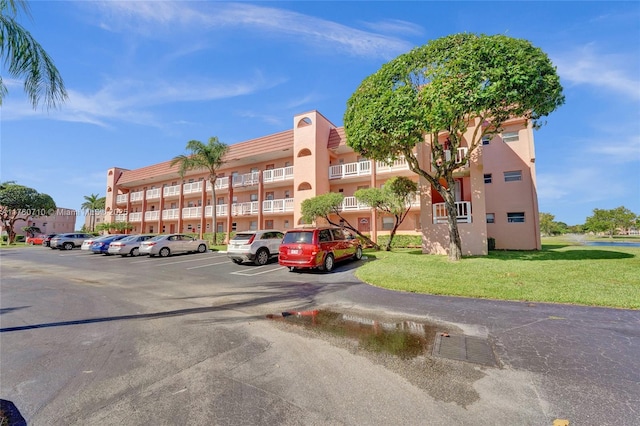 view of building exterior with uncovered parking