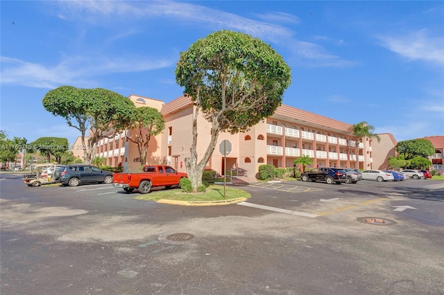 view of building exterior featuring uncovered parking