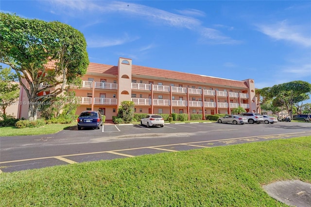 view of building exterior featuring uncovered parking