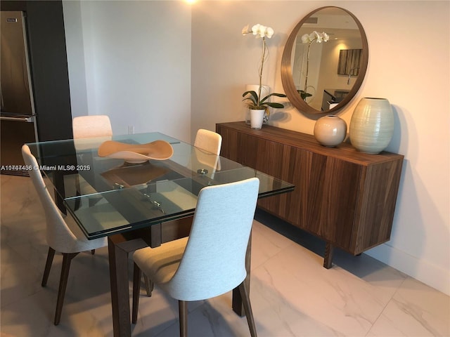 dining room with marble finish floor