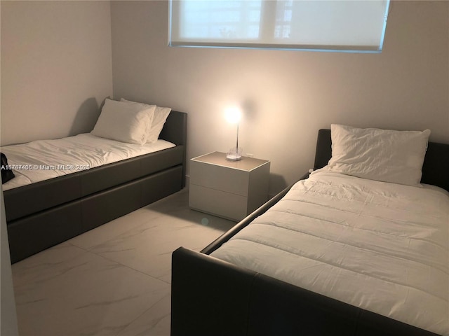 bedroom featuring marble finish floor