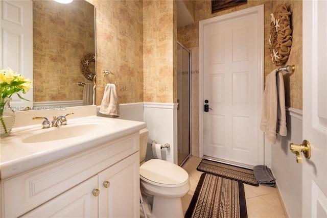 full bathroom with tile patterned flooring, toilet, a stall shower, and vanity