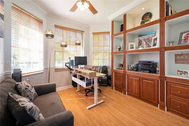 office area featuring a ceiling fan, baseboards, light wood-style floors, and crown molding