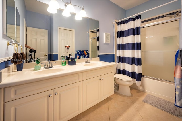 bathroom featuring tile patterned flooring, shower / bathtub combination with curtain, toilet, and a sink