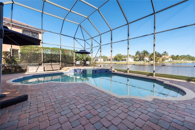 view of swimming pool featuring glass enclosure, a patio, a water view, and a pool with connected hot tub