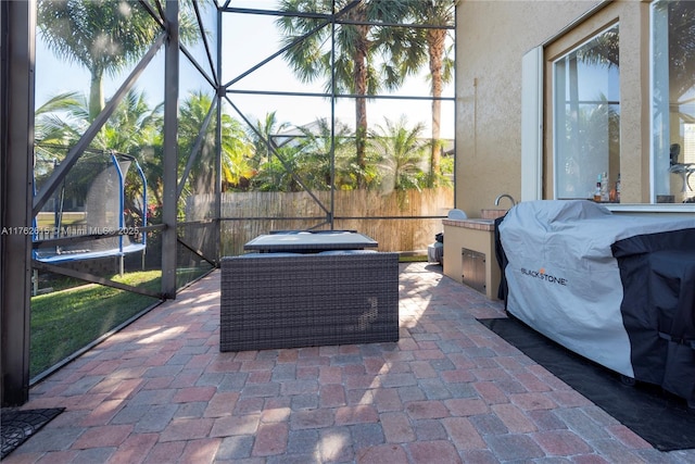 view of patio / terrace with a lanai and a trampoline