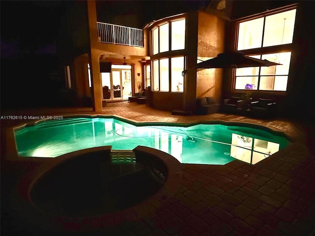 view of pool with a pool with connected hot tub and a patio area