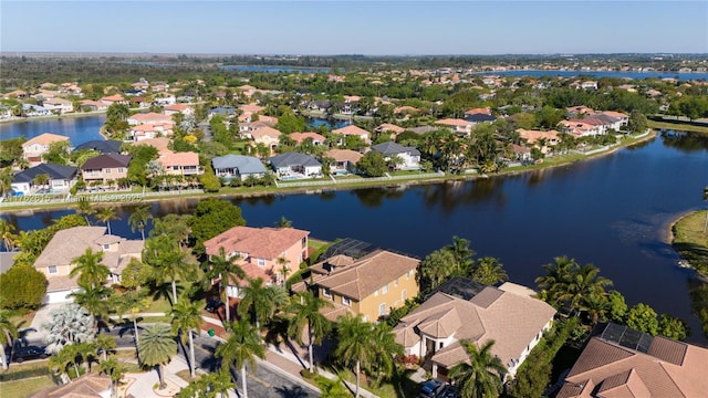 drone / aerial view featuring a residential view and a water view