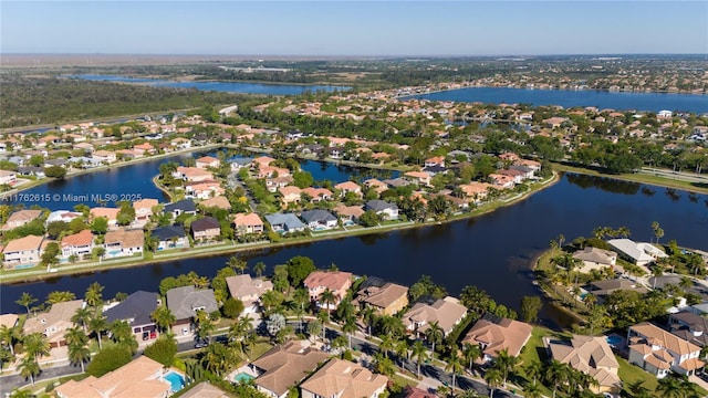 drone / aerial view with a residential view and a water view