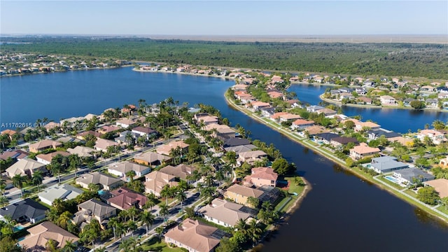 drone / aerial view with a residential view and a water view