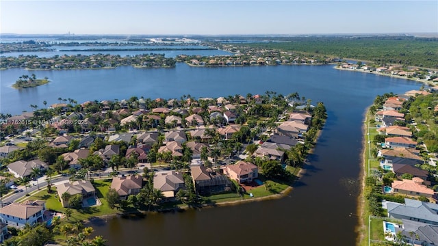 drone / aerial view with a residential view and a water view