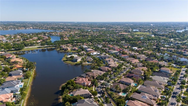 drone / aerial view featuring a residential view and a water view